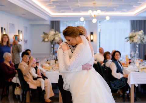 side-view-lovely-married-couple-which-hugging-dancing-first-wedding-dance-cozy-restaurant-while-their-family-guests.jpg